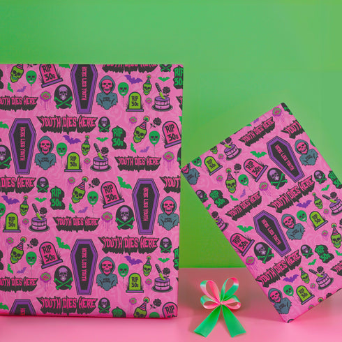 40th birthday Vibrant wrapping paper featuring a playful goth theme with illustrations of skulls, birthday cakes, and caskets marked "RIP 30s", set against a pink background with green accents. Ideal for themed 40th birthday gifts.